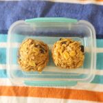 Two peanut butter balls in a container