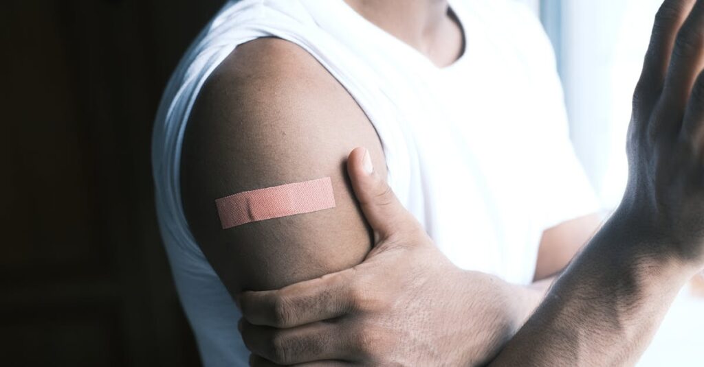 Man with band-aid on arm, symbolizing first aid or vaccination care.
