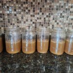 open Mason jars of bone broth lined up