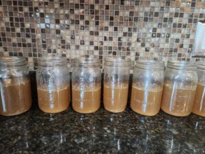 open Mason jars of bone broth lined up