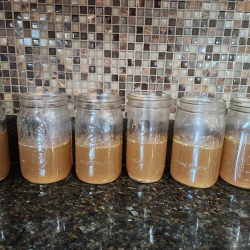 open Mason jars of bone broth lined up