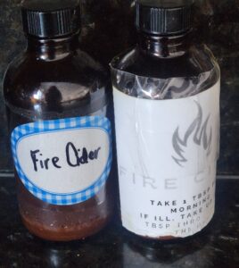 Small brown jars labeled fire cider